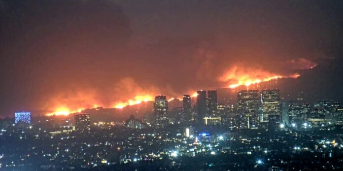 The Palisades Fire at night on the Los Angeles skyline.